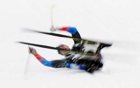 Ilya Pitalev. Australia’s Dominic Moneypenny falls during the 15-km cross-country event, sitting. Whistler, Canada