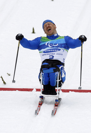 Ilya Pitalev. Gold medal winning Sergei Shilov glides through the finish line in the 1 km sprint event, sitting. Whistler, Canada
