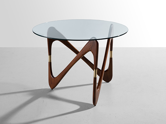 Coffee table with a figured base, 1950's (attributed to Cesare Lakka). Ebony wood, polished brass, clear glass. Courtesy of the Palisander Gallery