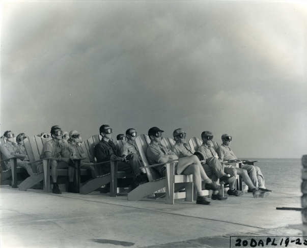 Operation name: Greenhouse.
Test name: Dog.	
Date and time: April 8, 1951, 06:33.
Location: Eniwetok Atoll, Pacific Ocean.
Yield: 81 kilotons.

VIP audience, illuminated by the explosion flash, watch the nuclear test.

Photo: unknown author.
Source: National Archives and Records Administration, Washington, USA