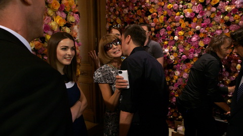 Raf Simons greets Anna Wintour in one of the flower rooms. Credit: CIM Productions