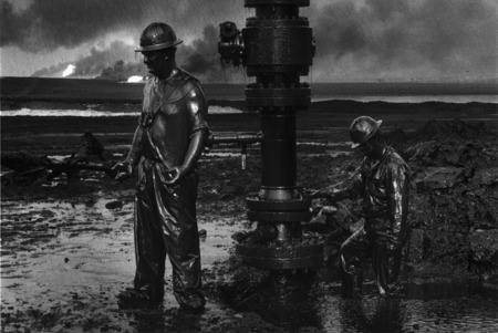 Sebastiano Salgado.
Workers mount a mouth of a chink to make possible input of chemicals. Big Burkhan, Kuwait. 
1991