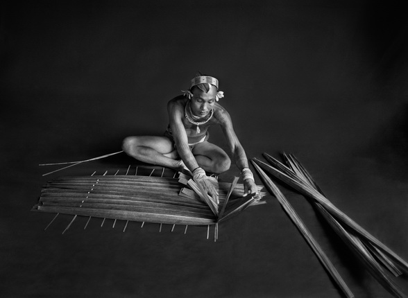 Teureum, sikeirei and leader of the Mentawai clan. 
This shaman is preparing a filter for sago, with the leaves of this same sago tree.
Siberut Island. West Sumatra. Indonesia. 2008.
Photograph by Sebastião SALGADO / Amazonas images