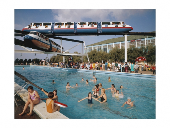David Noble. Butlin’s Minehead. Monorail over Outdoor Swimming Pool. 1967—1972 © John Hinde Archive
