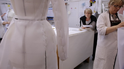 Head seamstresses Monique Bailly reviews a haute couture coat. Credit: CIM Productions