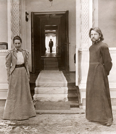 Yekaterina Ivanovna Tiutcheva with priest Feodor Maltsev by main entrance of estate house. Servant A. Gornostayev - at background